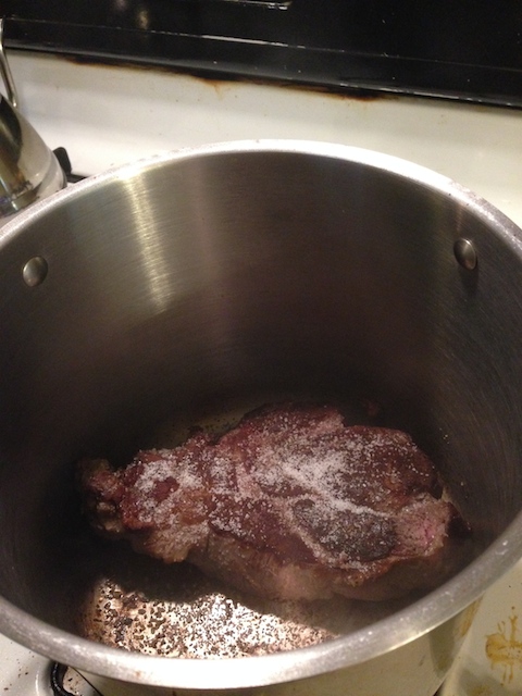 Chuck roast roasting in pot.